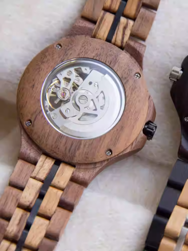 Black and gold transparent round skeletonized wooden men's automatic winding wooden watch with gold hands.